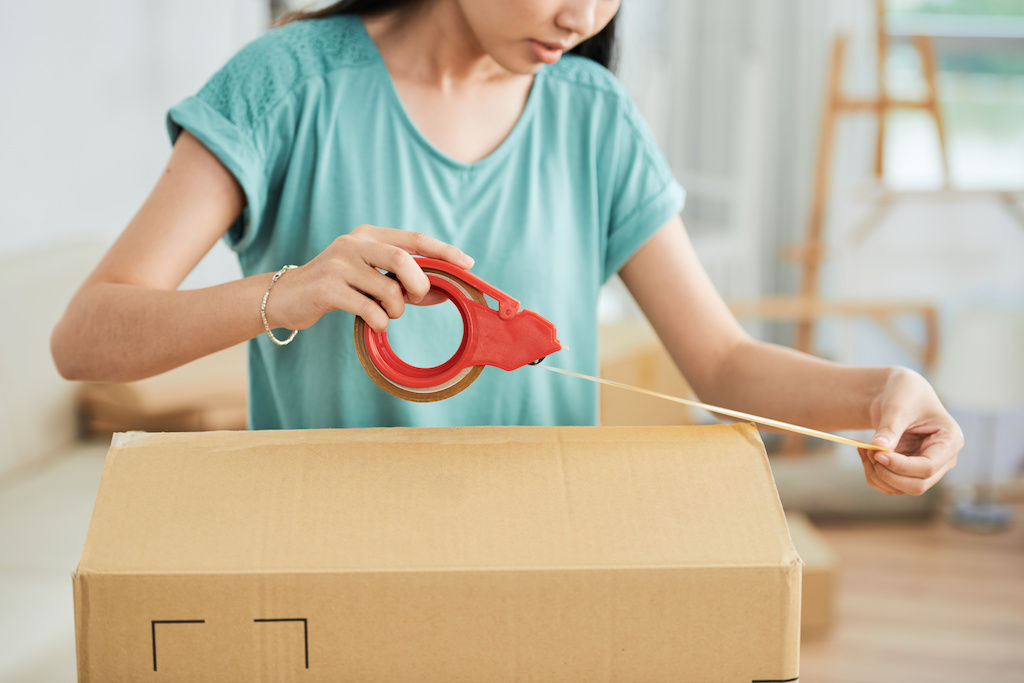 Woman taping moving box